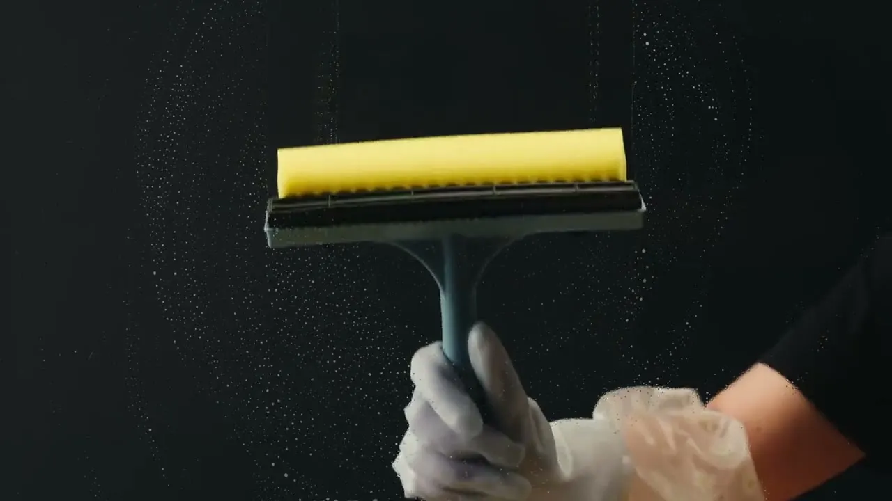 Close-up of a hand detailing a surface and edge during a thorough deep cleaning
